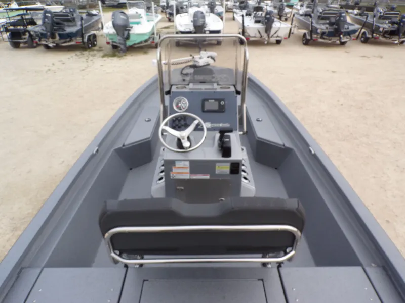 Slide: The Image of Xpress SW20B 2026 boat with steering console in a parking lot. - 22