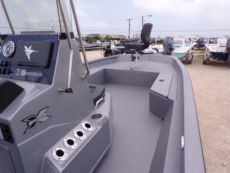 Slide: The Image of 2026 Xpress SW22B boat with gray deck and helm console. - 24
