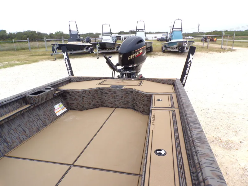 Slide: The Image of Xpress X18DB 2026 boat with Yamaha engine on parking lot. - 24