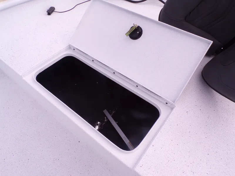 Slide: The Image of Open storage compartment on a 2026 Xpress XP20CC boat. - 19