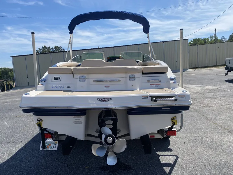 Slide: The Image of Rear view of a 2012 Chaparral 226 SSi boat in a parking lot. - 10