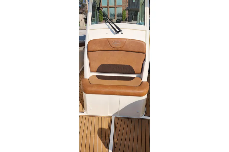 Slide: The Image of 2015 Scout 320 LXF boat seat with brown leather upholstery and teak flooring. - 6