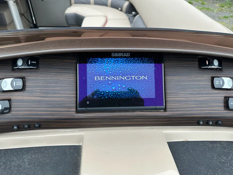 Slide: The Image of Bennington 23 LSR 2022 dashboard with Simrad display. - 13