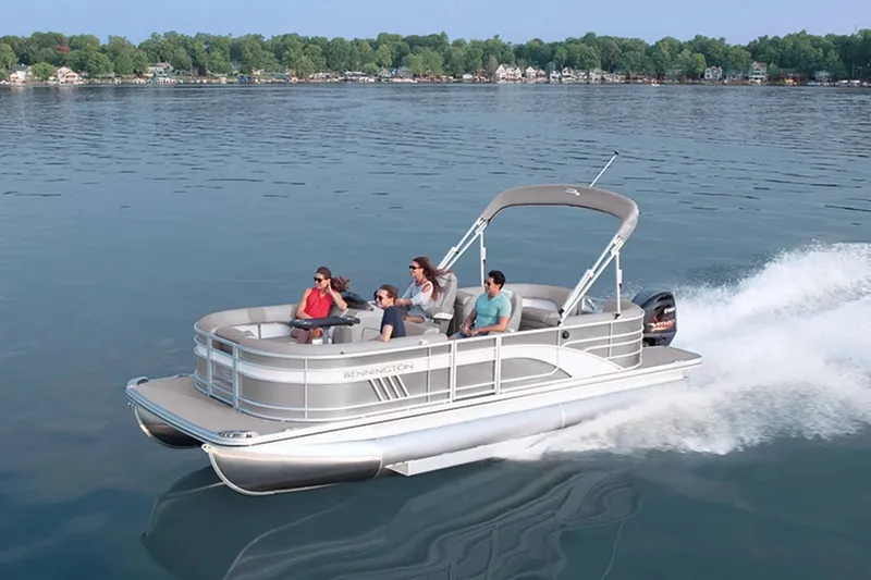 Slide: The Image of Bennington 23 LSR 2022 pontoon boat cruising on a serene lake. - 17