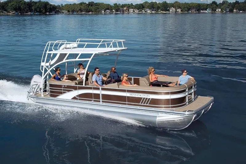 Slide: The Image of Bennington 23 LSR 2022 pontoon boat cruising on a calm lake. - 19