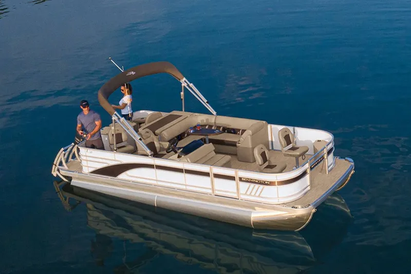 Slide: The Image of 2022 Bennington 23 LSR pontoon boat on calm water. - 20