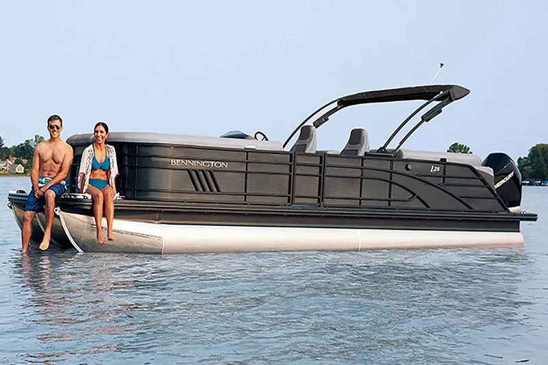 Slide: The Image of 2022 Bennington 23 LSR pontoon boat on water with two people. - 22
