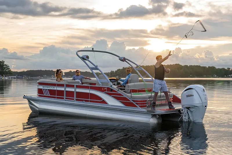 Slide: The Image of Bennington 23 LSR 2022 pontoon boat on calm water at sunset. - 28
