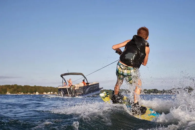 Slide: The Image of Wakeboarder behind a 2022 Bennington 23 LSR boat. - 31