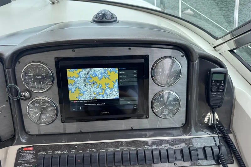 Slide: The Image of Control panel of a 2004 Sea Ray 390 Sundancer with navigation display and gauges. - 10