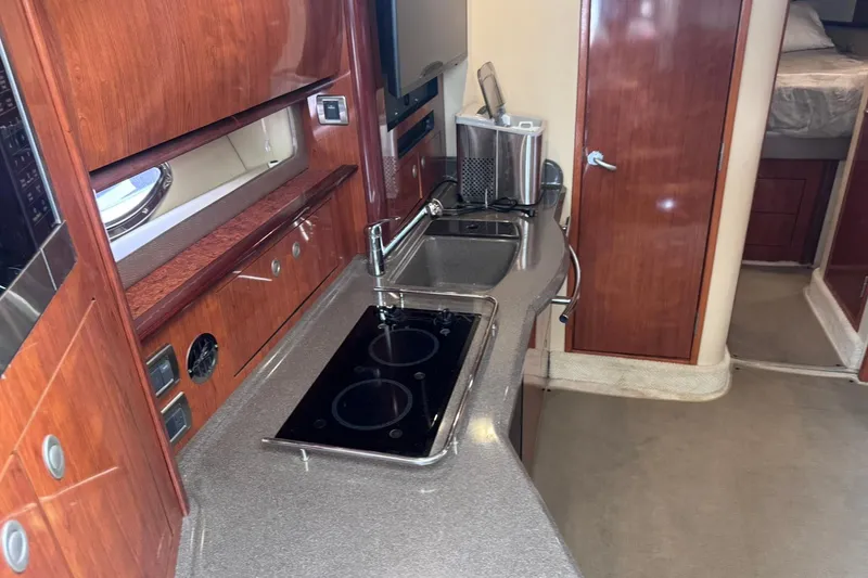 Slide: The Image of Luxurious 2004 Sea Ray 390 Sundancer yacht interior with modern kitchen amenities. - 12