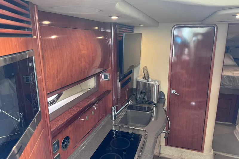 Slide: The Image of Interior of 2004 Sea Ray 390 Sundancer yacht with wood cabinetry and modern amenities. - 14