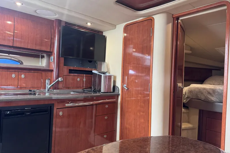 Slide: The Image of Interior of 2004 Sea Ray 390 Sundancer yacht with wood cabinetry and modern amenities. - 15