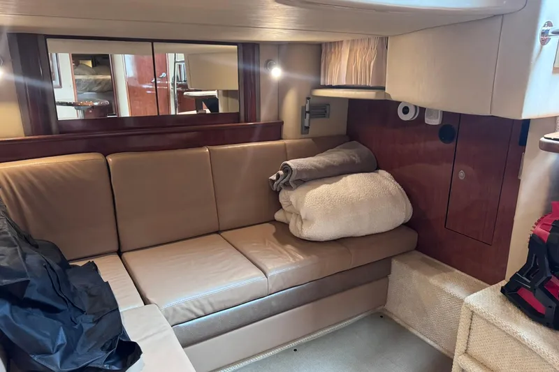 Slide: The Image of Interior of 2004 Sea Ray 390 Sundancer yacht with beige leather seating and cozy blankets. - 16