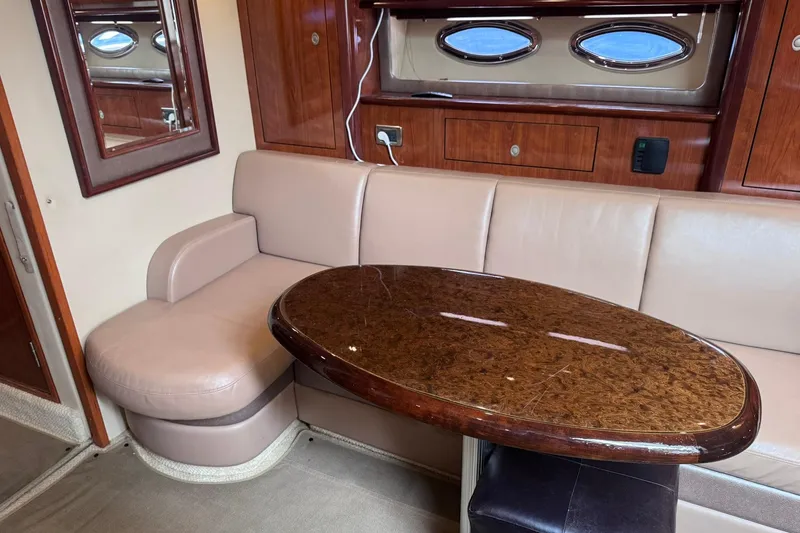Slide: The Image of Luxurious interior of 2004 Sea Ray 390 Sundancer with elegant seating and polished wood table. - 17