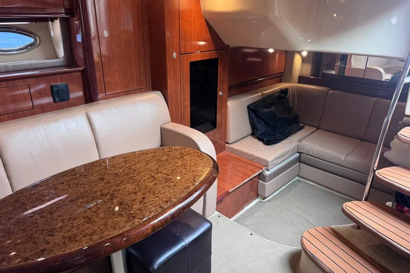 Slide: The Image of Luxurious interior of 2004 Sea Ray 390 Sundancer yacht with elegant seating and wooden finishes. - 18