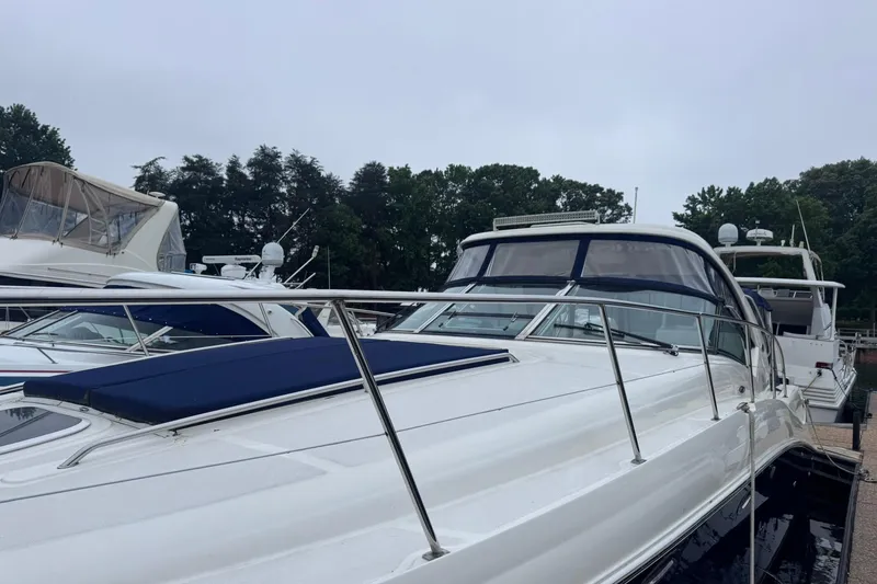 Slide: The Image of 2004 Sea Ray 390 Sundancer yacht docked, featuring sleek design and spacious deck. - 2