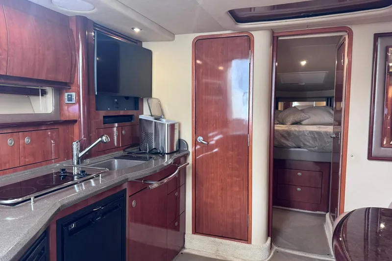 Slide: The Image of Luxurious interior of 2004 Sea Ray 390 Sundancer yacht with modern kitchen and cozy bedroom. - 23