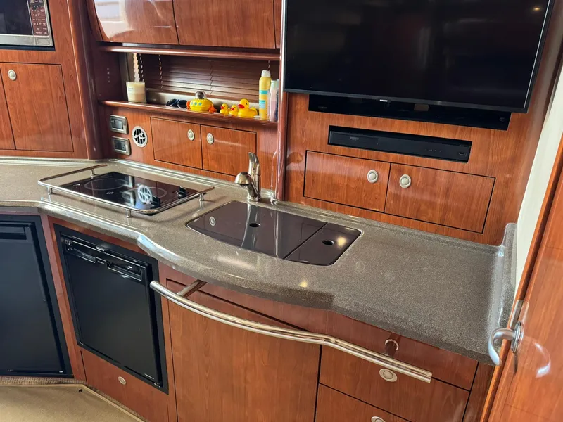 Slide: The Image of Luxurious kitchen area in 2004 Sea Ray 390 Sundancer yacht with modern amenities. - 25