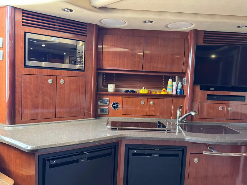 Slide: The Image of Luxurious 2004 Sea Ray 390 Sundancer yacht interior with modern kitchen amenities. - 26