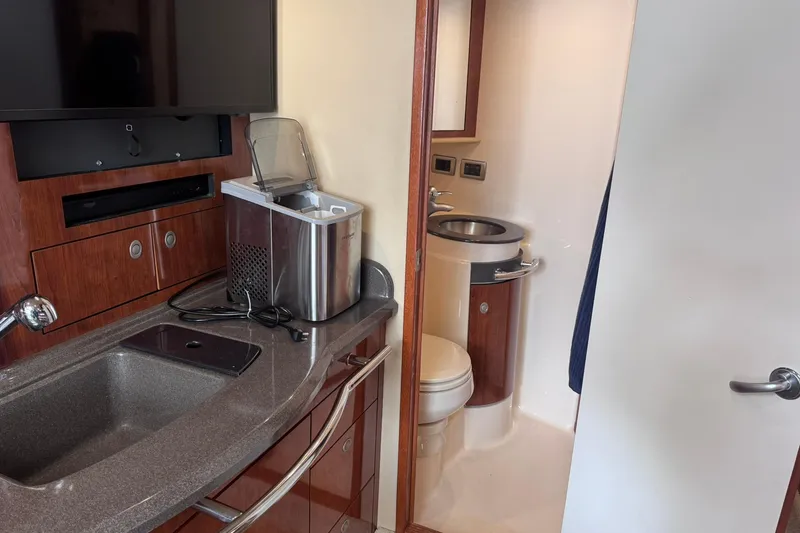 Slide: The Image of Interior of 2004 Sea Ray 390 Sundancer yacht with kitchenette and bathroom. - 28