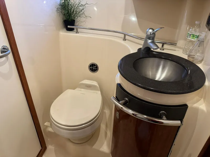Slide: The Image of 2004 Sea Ray 390 Sundancer bathroom with toilet, sink, and modern fixtures. - 30