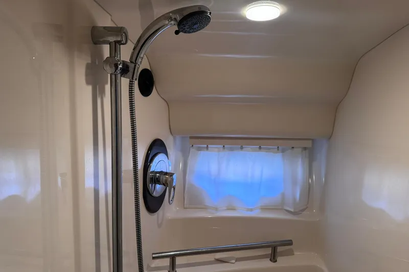 Slide: The Image of Shower area in 2004 Sea Ray 390 Sundancer yacht, featuring modern fixtures and window. - 31