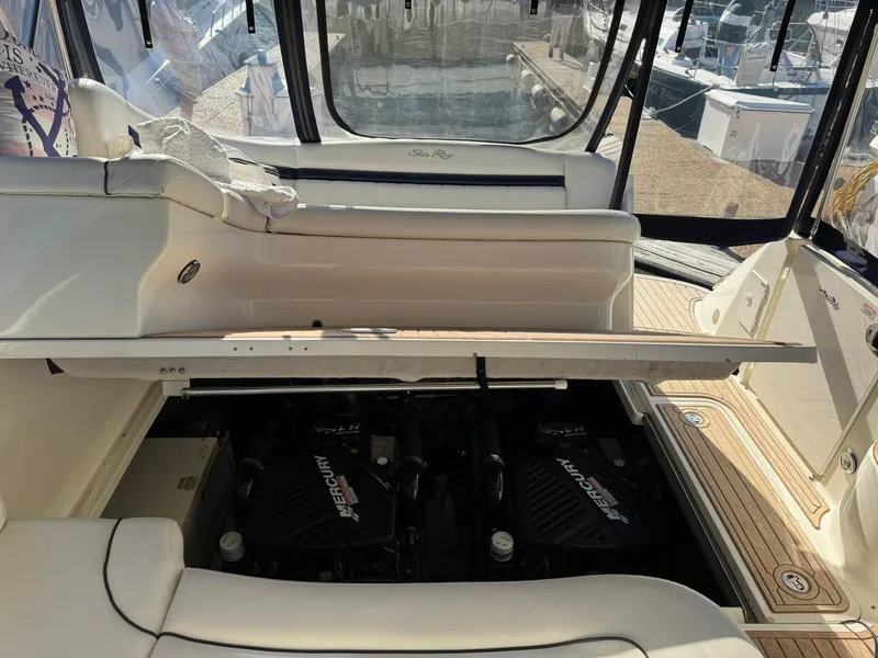 Slide: The Image of 2004 Sea Ray 390 Sundancer engine compartment with twin Mercury engines visible. - 33