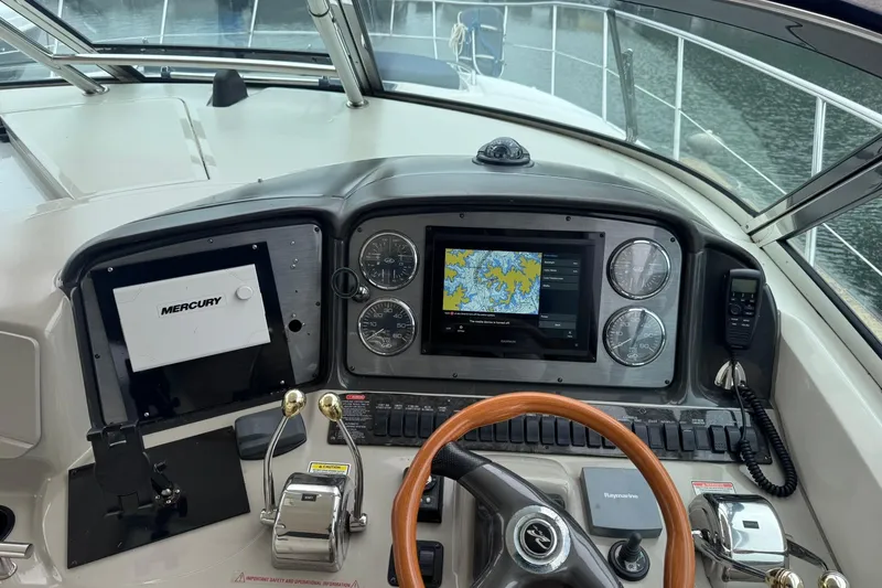 Slide: The Image of Cockpit of 2004 Sea Ray 390 Sundancer with navigation system and controls. - 9