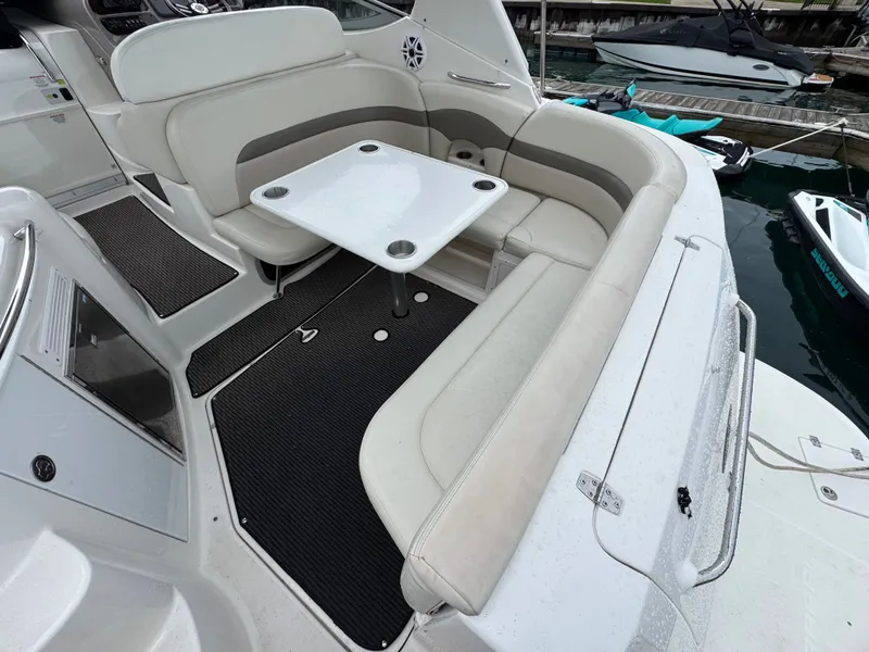 Slide: The Image of Interior of a 2008 Chaparral 310 Signature with seating area and table. - 2