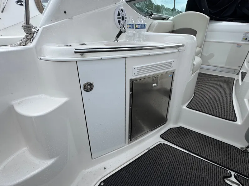 Slide: The Image of Interior of a 2008 Chaparral 310 Signature with fridge and seating area. - 3
