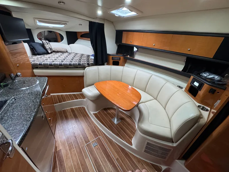 Slide: The Image of Interior of a 2008 Chaparral 310 Signature yacht with kitchen and seating area. - 6