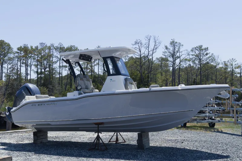 The Image of 2026 Key West 249 FS boat on display, elevated on stands, surrounded by trees. - 0