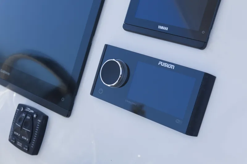 Slide: The Image of Control panel of 2026 Key West 249 FS boat featuring Garmin and Fusion displays. - 13