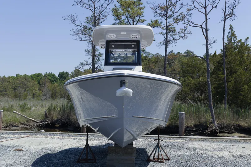 Slide: The Image of Front view of 2026 Key West 249 FS boat on stands, surrounded by trees. - 2