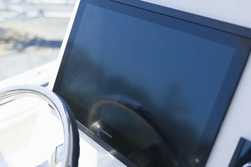 Slide: The Image of Steering wheel and Garmin display on 2026 Key West 249 FS boat. - 21