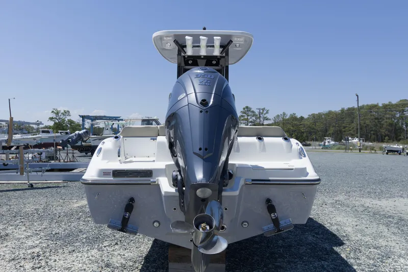 Slide: The Image of 2026 Key West 249 FS boat with powerful outboard motor, parked on gravel lot. - 5