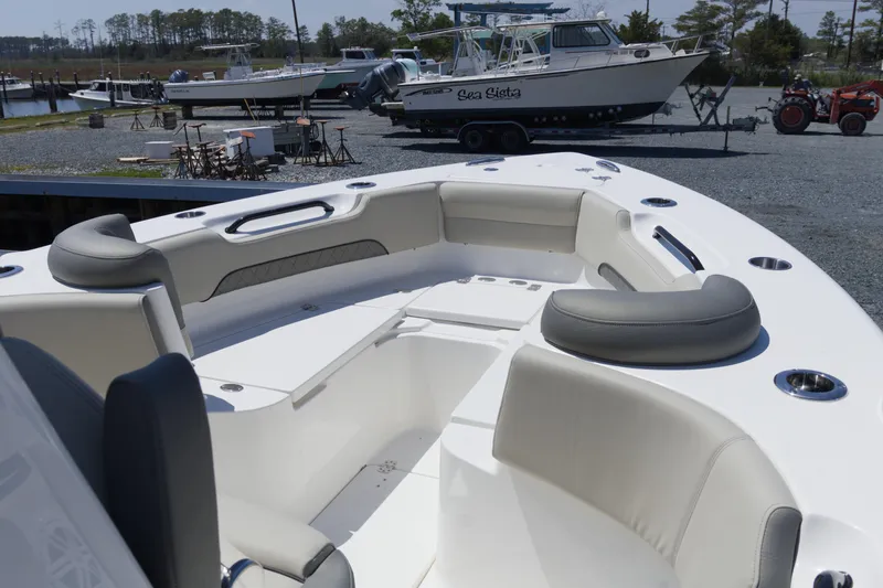 Slide: The Image of 2026 Key West 249 FS boat interior with cushioned seating and cup holders. - 8