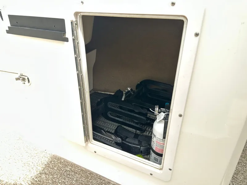 Slide: The Image of Storage compartment in 2014 Chaparral 210 H20 FISH & SKI boat. - 28