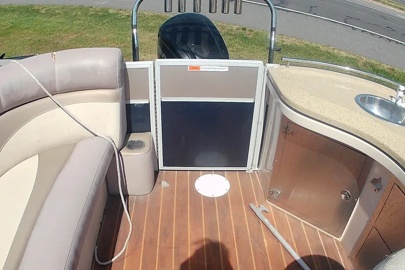 Slide: The Image of Interior of 2015 Crest 230 bar boat with seating, sink, and wooden flooring. - 4