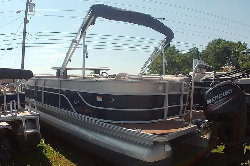 Slide: The Image of 2015 Crest 230 bar pontoon boat with Mercury outboard motor, parked outdoors. - 5