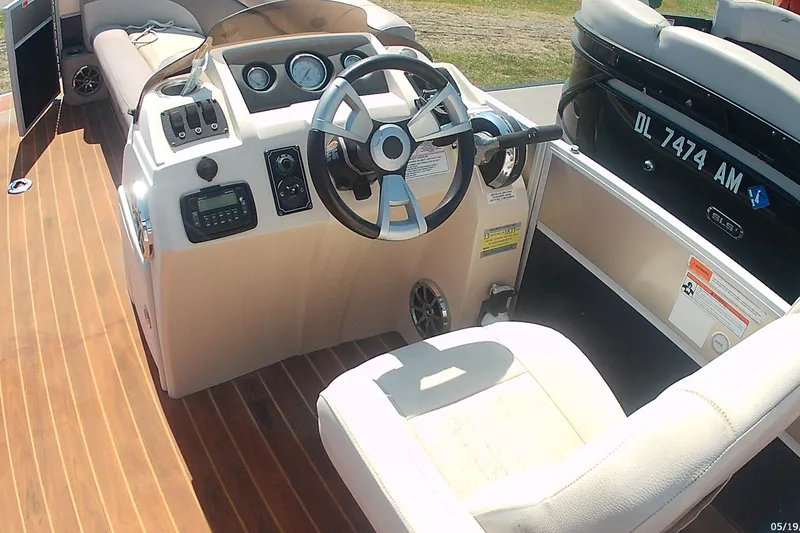 Slide: The Image of Interior view of a 2015 Crest 230 bar boat with steering wheel and seating. - 6