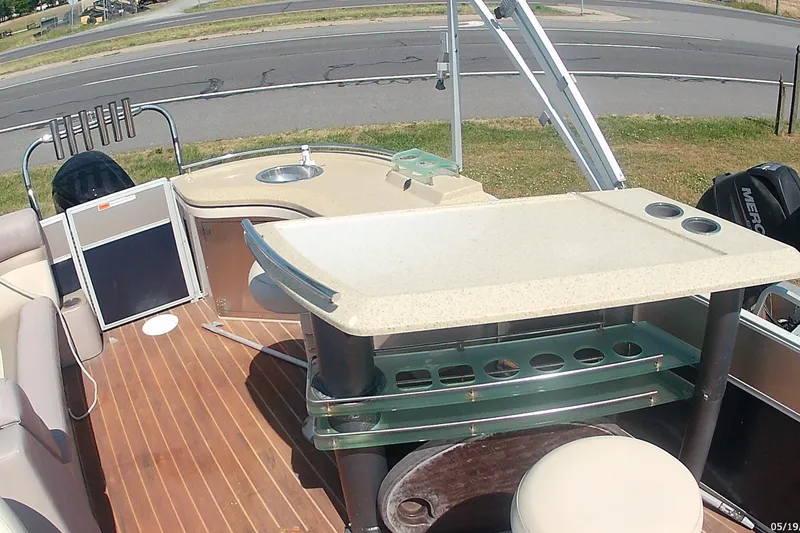 Slide: The Image of 2015 Crest 230 Bar pontoon boat interior with bar, seating, and sink. - 7