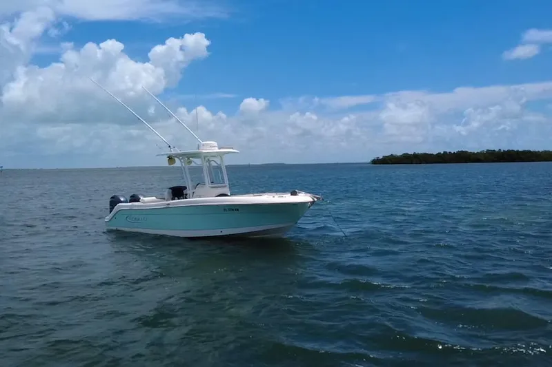 The Image of 2019 Robalo R242 Center Console boat on calm blue waters under a clear sky. - 0