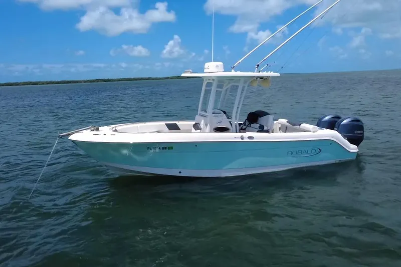 Slide: The Image of 2019 Robalo R242 Center Console boat on calm ocean waters under blue sky. - 10