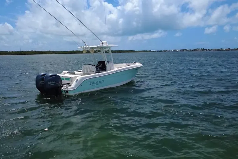 Slide: The Image of 2019 Robalo R242 Center Console boat on open water under blue sky. - 11