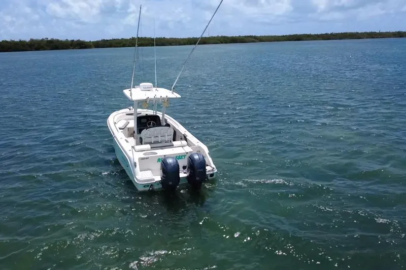 Slide: The Image of 2019 Robalo R242 Center Console boat on open water, twin engines visible. - 14
