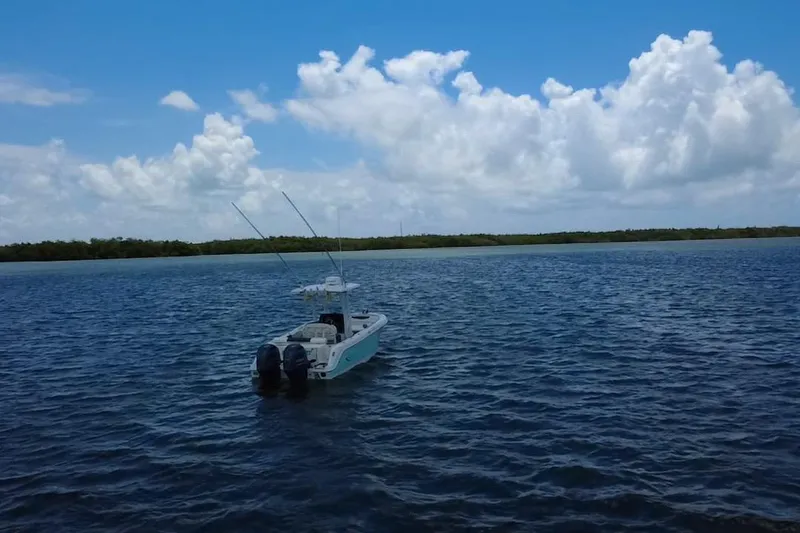 Slide: The Image of 2019 Robalo R242 Center Console boat on open water under a blue sky. - 17
