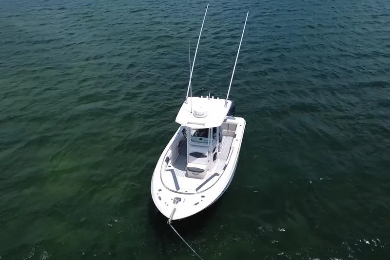 Slide: The Image of 2019 Robalo R242 Center Console boat on open water, aerial view. - 21