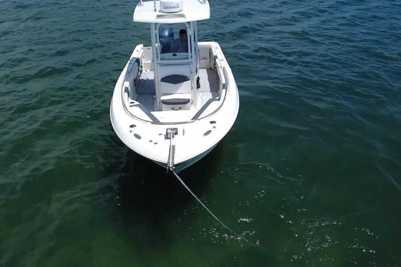 Slide: The Image of 2019 Robalo R242 Center Console boat anchored on calm water. - 22